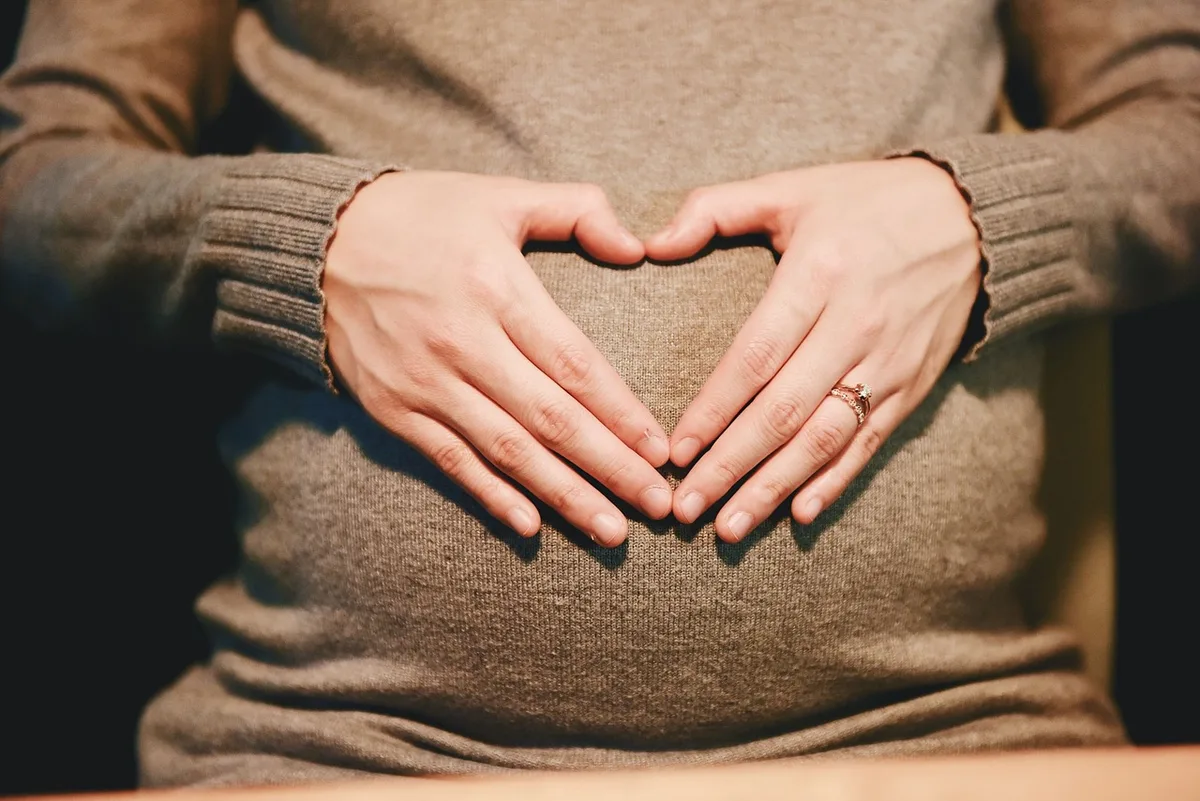 Femme enceinte tenant des compléments alimentaires prénatals