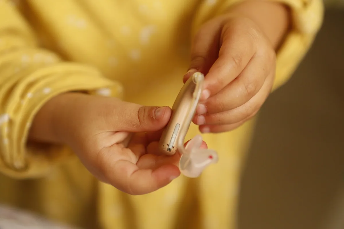 Jeune patient lors d'une consultation médicale pour un suivi auditif et métabolique